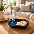 Shoreline Candle styled on a wood coffee table in a bright coastal living room