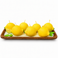 Citrus Grove Candle - hand-poured lemon-shaped soy wax candles on a wood tray with green leaf accents