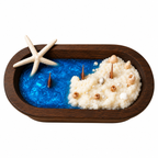 Shoreline Candle in an oval wood vessel with blue wax, white sand and a starfish