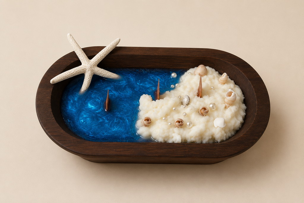 An oval wooden tray holding a decorative beach-themed object: a bright blue resin-like surface with a white textured mound resembling sand, small shells, and a white starfish on the side, set against a plain beige background.