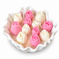 Petal Bloom Candle with pink and cream wax tulip buds in a white scalloped bowl