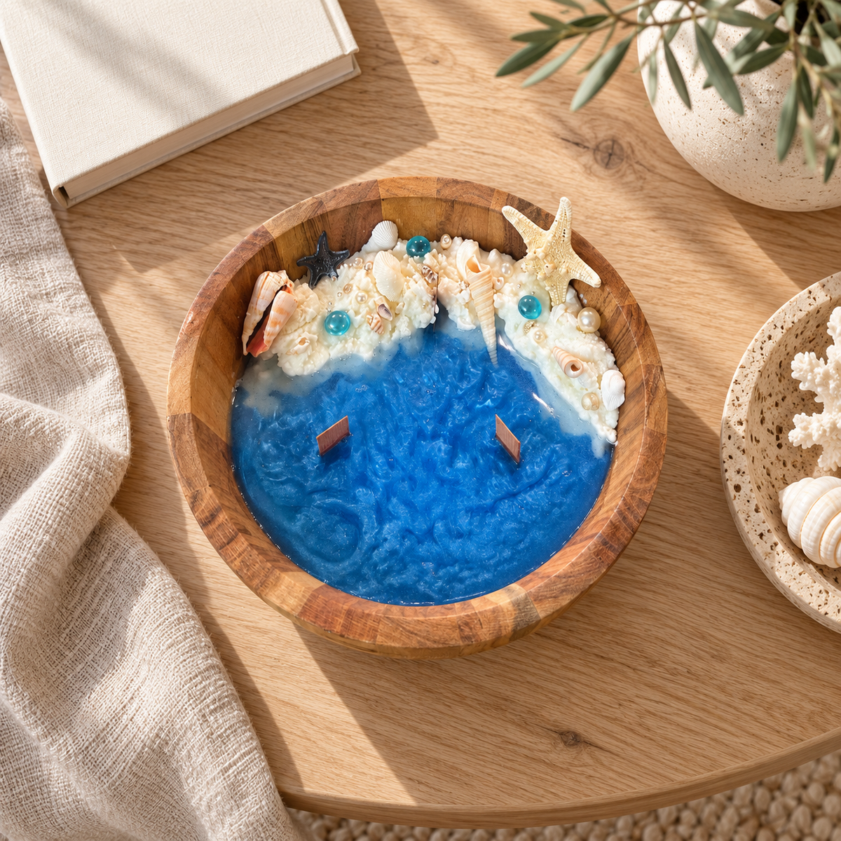 Ocean Bowl Candle seen from above on an oak table with a book and dried coral